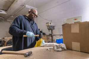 Baker Industries employee hammering