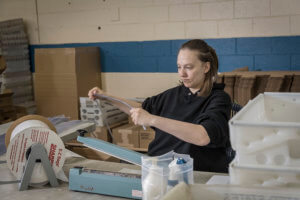 Baker Industries employee packing bags