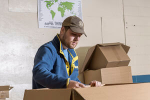 Baker Industries employee packs boxes