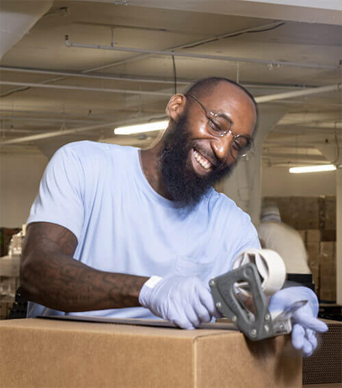 Baker Employee taping boxes