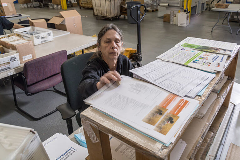 Baker Employee Preparing Mail