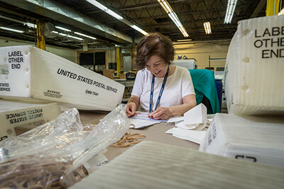 Baker Employees preparing mail and packages