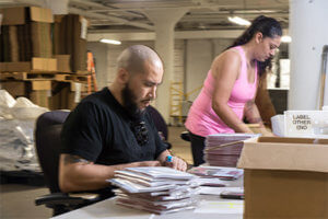 Baker Employees preparing mail and packages